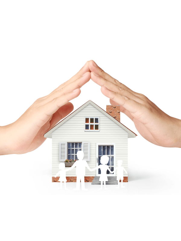 Hands protecting a house model.